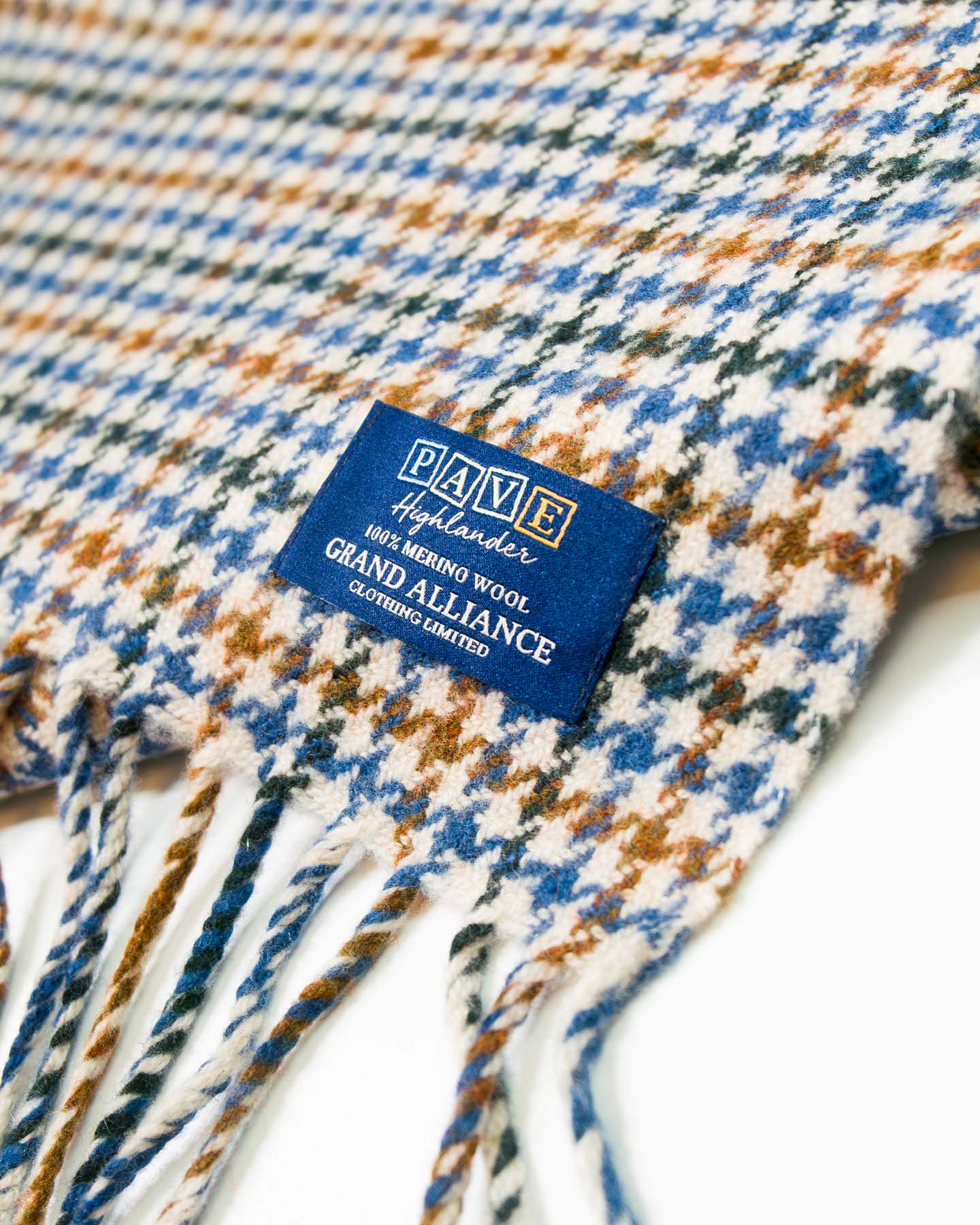 Close-up of a plaid fabric with a brand label on a white background